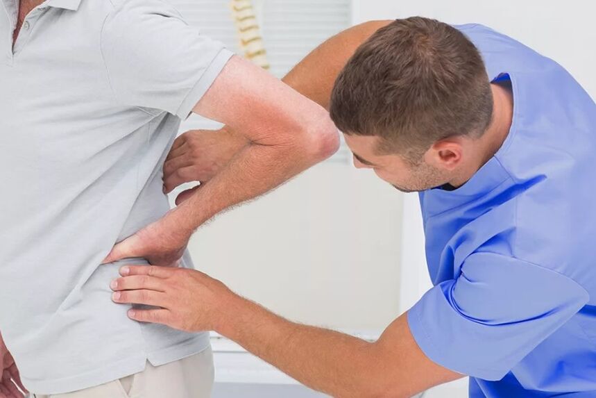 Patient with lower back pain on diagnostic examination of doctors